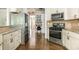 Well-equipped kitchen with stainless steel appliances and ample cabinet space open to a desk area at 12350 Stevens Creek Dr, Alpharetta, GA 30005