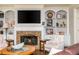 Cozy living room showcasing a stone fireplace with built-in shelving at 12350 Stevens Creek Dr, Alpharetta, GA 30005