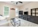 Cozy living room boasts natural light, ceiling fan, a dark entertainment center, and comfortable seating area at 12350 Stevens Creek Dr, Alpharetta, GA 30005