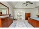 Elegant main bedroom featuring a decorative rug, wood furnishings, and a tray ceiling at 12350 Stevens Creek Dr, Alpharetta, GA 30005