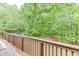 Spacious back deck with railings offering serene views of the private, wooded surroundings at 2682 Freemans Walk Path, Dacula, GA 30019