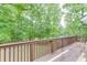 Back deck overlooking a lush, wooded backyard, perfect for outdoor relaxation at 2682 Freemans Walk Path, Dacula, GA 30019