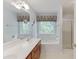 Bathroom featuring a vanity with double sinks, a soaking tub, and glass-enclosed shower at 2682 Freemans Walk Path, Dacula, GA 30019