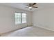 Bedroom with neutral carpet and view of large window and outdoor nature at 2682 Freemans Walk Path, Dacula, GA 30019