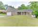 Single-story brick house featuring a two-car garage, a well-kept lawn, and an inviting covered front porch at 2682 Freemans Walk Path, Dacula, GA 30019
