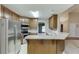 Spacious kitchen featuring stainless steel appliances, ample wooden cabinetry, and a convenient breakfast bar at 2682 Freemans Walk Path, Dacula, GA 30019