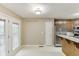 Kitchen nook with a stainless steel refrigerator, neutral walls, and access to an outdoor balcony at 2682 Freemans Walk Path, Dacula, GA 30019