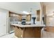 An open kitchen features stainless steel appliances, a bar area, and views of the entry and front door at 2682 Freemans Walk Path, Dacula, GA 30019