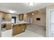 Kitchen with tiled backsplash and stainless appliances open to the vaulted ceiling living room at 2682 Freemans Walk Path, Dacula, GA 30019