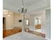 Open-concept living room featuring hardwood floors and seamlessly connecting dining room and kitchen at 2682 Freemans Walk Path, Dacula, GA 30019
