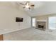 Spacious living room with vaulted ceiling, fireplace, and view of the backyard through windows at 2682 Freemans Walk Path, Dacula, GA 30019