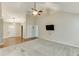 Open living room with vaulted ceiling, ceiling fan, mounted television, and hardwood entry at 2682 Freemans Walk Path, Dacula, GA 30019