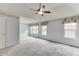 Large main bedroom with vaulted ceilings, carpet, ceiling fan, and bright windows at 2682 Freemans Walk Path, Dacula, GA 30019