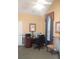 Well-lit home office featuring large desk, high ceiling, neutral walls and arched window with blind and curtain at 3024 Orchard Ridge Cir, Duluth, GA 30096