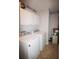 Well-lit laundry room with white washer and dryer for convenience at 3024 Orchard Ridge Cir, Duluth, GA 30096