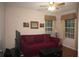 Cozy living room with a red couch, two windows, and a ceiling fan at 3024 Orchard Ridge Cir, Duluth, GA 30096