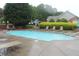 Community pool surrounded by lush greenery and comfortable lounge chairs for relaxation at 3024 Orchard Ridge Cir, Duluth, GA 30096