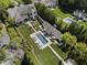 Aerial view showcasing the estate, pool, and lush landscaping that creates a private oasis at 3888 Peachtree Dunwoody Rd, Atlanta, GA 30342