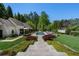 Beautiful backyard with mature landscaping, a large pool, and a covered outdoor dining area at 3888 Peachtree Dunwoody Rd, Atlanta, GA 30342