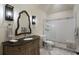 Bathroom features a vanity with granite countertop and a walk-in shower with subway tile at 3888 Peachtree Dunwoody Rd, Atlanta, GA 30342