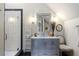 Bathroom with gray vanity, marble countertops, and a glass enclosed shower at 3888 Peachtree Dunwoody Rd, Atlanta, GA 30342