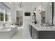 Luxurious bathroom featuring a soaking tub, dual vanities, and modern fixtures at 3888 Peachtree Dunwoody Rd, Atlanta, GA 30342