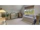 Bedroom featuring crib, sitting area, daybed, and bright natural light at 3888 Peachtree Dunwoody Rd, Atlanta, GA 30342