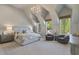 Bright bedroom with vaulted ceilings, plush carpet, sitting area, and lots of natural light at 3888 Peachtree Dunwoody Rd, Atlanta, GA 30342