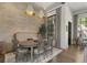 Cozy dining area featuring a round wooden table, comfortable seating, and stylish pendant lighting fixtures at 3888 Peachtree Dunwoody Rd, Atlanta, GA 30342