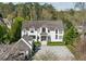 Stunning two-story home with a white exterior, complemented by lush landscaping and a gray tile roof at 3888 Peachtree Dunwoody Rd, Atlanta, GA 30342