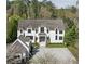 Stunning home featuring a light grey driveway, manicured lawn and eye-catching black-trim windows at 3888 Peachtree Dunwoody Rd, Atlanta, GA 30342