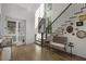 Bright foyer featuring hardwood floors, staircase, and natural light at 3888 Peachtree Dunwoody Rd, Atlanta, GA 30342