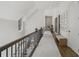 Upstairs hallway with hardwood floors, carpet runner, and decorative architectural details at 3888 Peachtree Dunwoody Rd, Atlanta, GA 30342