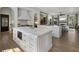 Open-concept kitchen with double islands, marble countertops, modern appliances, and seamless flow to living area at 3888 Peachtree Dunwoody Rd, Atlanta, GA 30342
