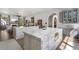 Inviting kitchen with double islands, marble countertops, gray cabinetry, and open view to the living room at 3888 Peachtree Dunwoody Rd, Atlanta, GA 30342