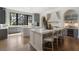 Bright kitchen boasting double islands, stainless steel appliances, gray cabinetry, and a wine fridge at 3888 Peachtree Dunwoody Rd, Atlanta, GA 30342