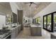 Open gourmet kitchen with professional appliances, custom cabinets, island seating, and view to the living area at 3888 Peachtree Dunwoody Rd, Atlanta, GA 30342