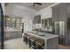 Spacious kitchen with modern stainless appliances, custom cabinetry, and large island with seating at 3888 Peachtree Dunwoody Rd, Atlanta, GA 30342