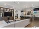 Open concept living room features an adjacent bar and entertainment center with tv at 3888 Peachtree Dunwoody Rd, Atlanta, GA 30342