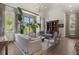 Spacious living room featuring high ceilings, large windows, and elegant chandelier at 3888 Peachtree Dunwoody Rd, Atlanta, GA 30342