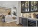 Open-concept living room with hardwood floors, built-in bar area, and view of the dining area at 3888 Peachtree Dunwoody Rd, Atlanta, GA 30342