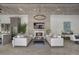 Open concept living room with comfortable sofas, fireplace, modern lighting, and views into kitchen at 3888 Peachtree Dunwoody Rd, Atlanta, GA 30342
