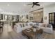Open-concept living room and kitchen area, complete with a plush sofa and a rustic coffee table at 3888 Peachtree Dunwoody Rd, Atlanta, GA 30342