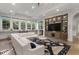 Bright living room featuring a modern couch, large windows, and an entertainment center with tv at 3888 Peachtree Dunwoody Rd, Atlanta, GA 30342
