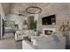 Open living area with fireplace, mounted television, rustic accents, and eat in kitchen area at 3888 Peachtree Dunwoody Rd, Atlanta, GA 30342