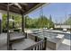 Covered patio with swing and backyard views featuring a swimming pool, spa, outdoor fireplace, and manicured lawn at 3888 Peachtree Dunwoody Rd, Atlanta, GA 30342