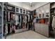 Organized walk-in closet with custom shelving, drawers, and ample storage space at 3888 Peachtree Dunwoody Rd, Atlanta, GA 30342