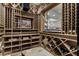 Custom wine cellar offers ample storage with wooden racking and display shelves at 3888 Peachtree Dunwoody Rd, Atlanta, GA 30342