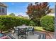 Backyard area with a patio, outdoor furniture, trimmed hedges, and a maple tree at 655 Grove Manor Ct, Suwanee, GA 30024