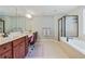 Primary bathroom with dual vanities, soaking tub, enclosed shower, and neutral tones at 655 Grove Manor Ct, Suwanee, GA 30024